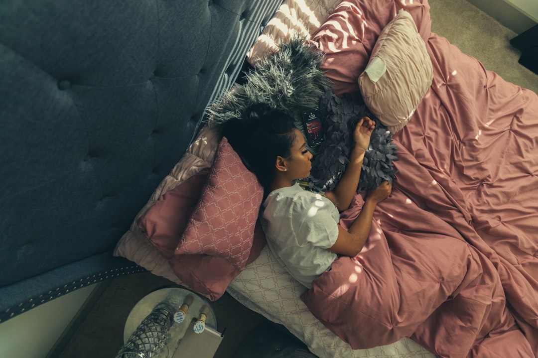 girl in orange dress lying on bed