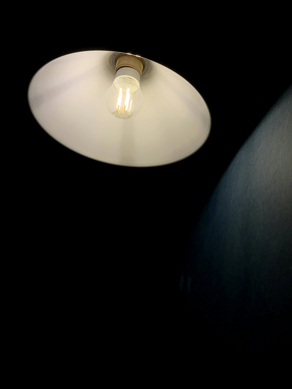 white pendant lamp turned on in room
