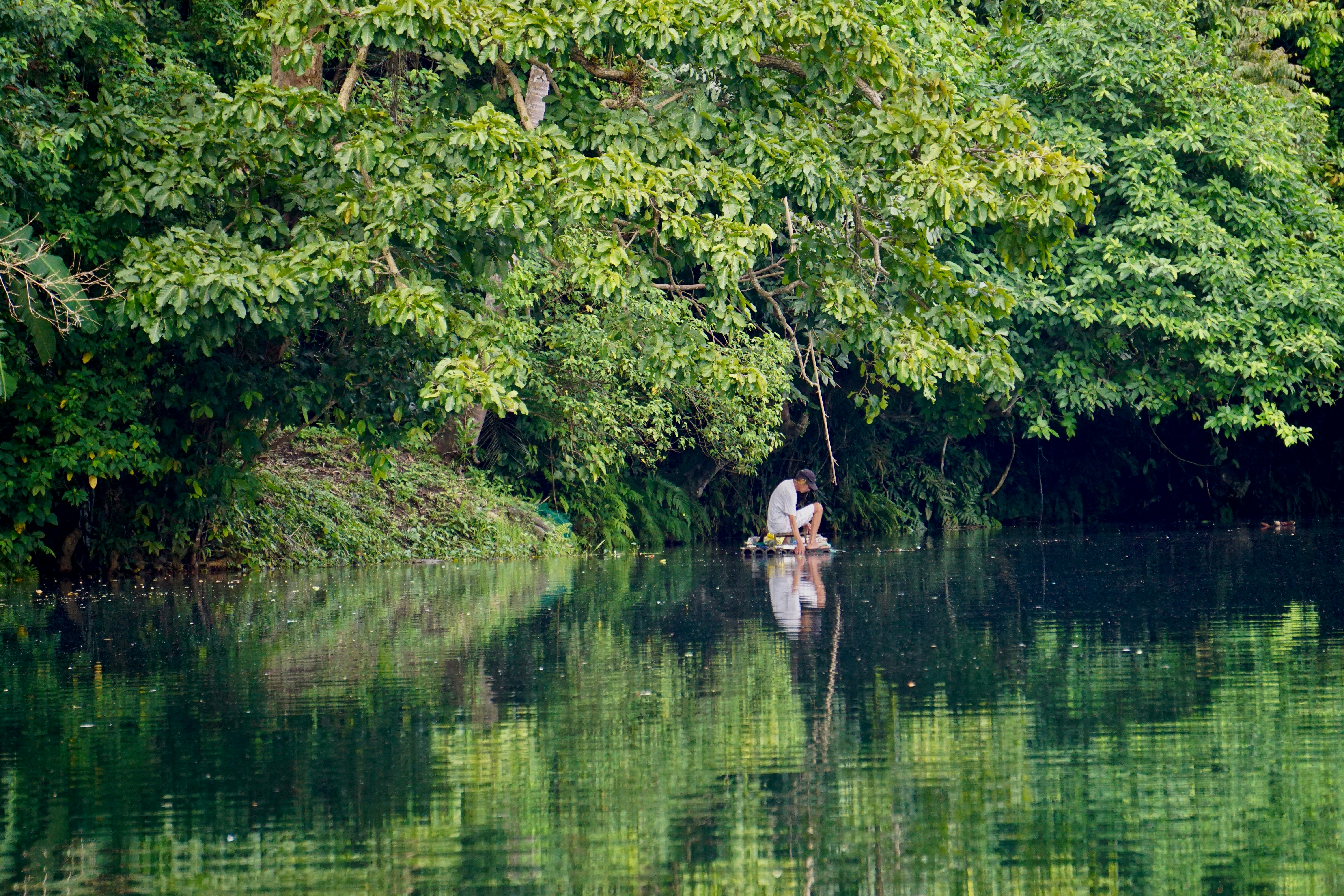 2 people on brown boat on lake during daytime, 