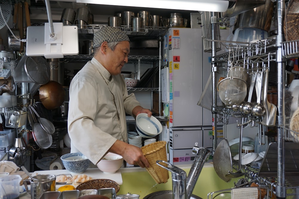 man in white chef uniform cooking