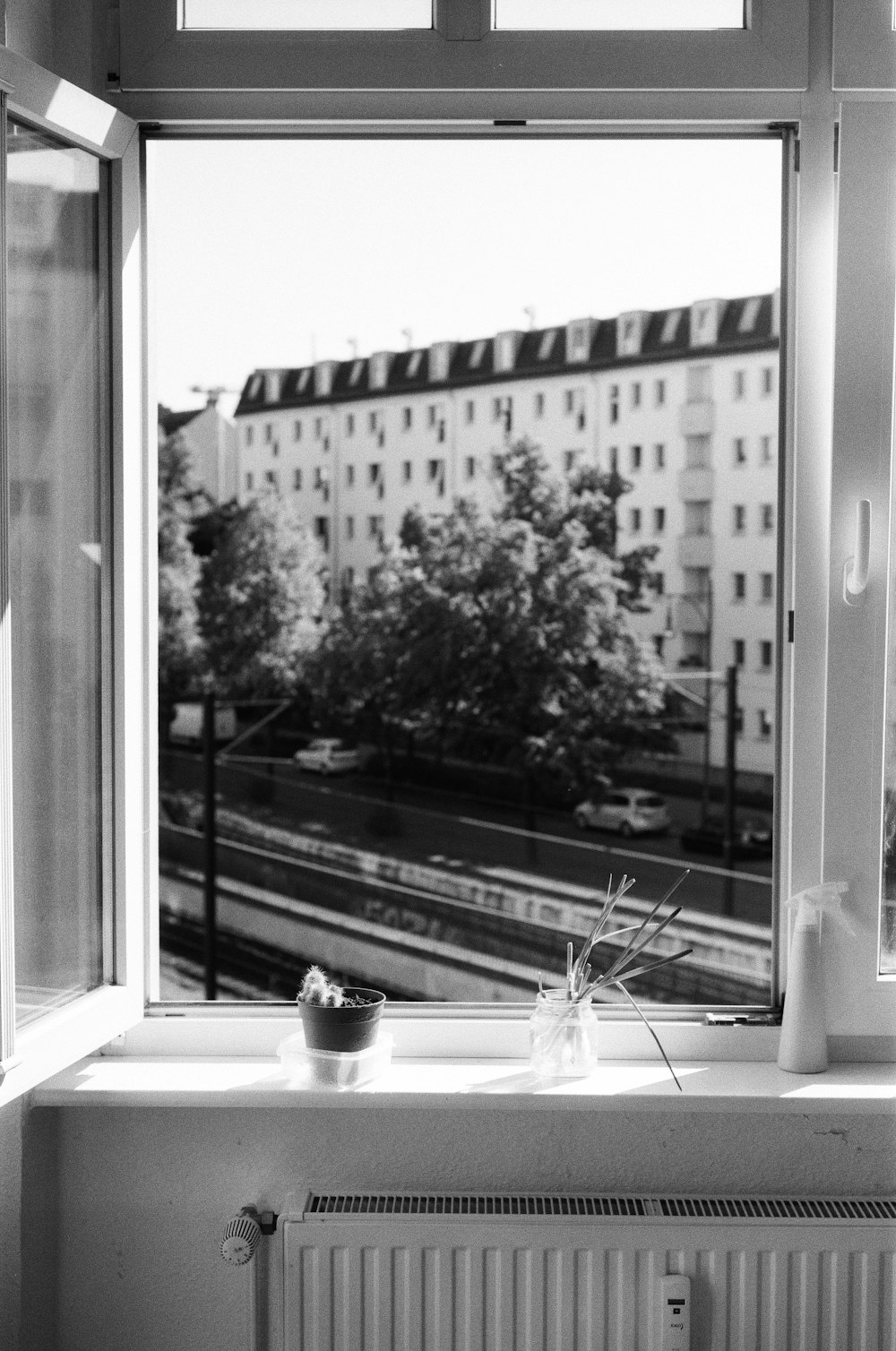 grayscale photo of window with water droplets