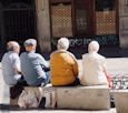 people sitting on gray concrete bench during daytime