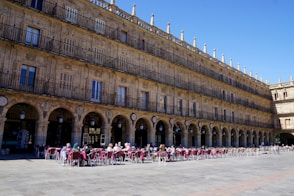 people in front of brown concrete building during daytime