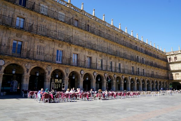 Café tables under the arcades of the Plaza Mayor — Salamanca, Spain