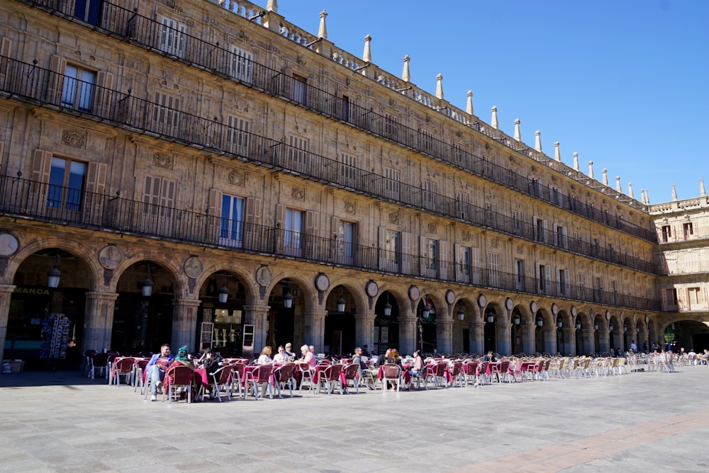 people in front of brown concrete building during daytime