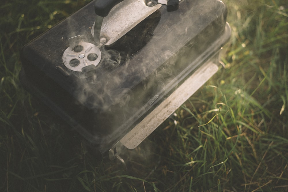 black metal tool on green grass