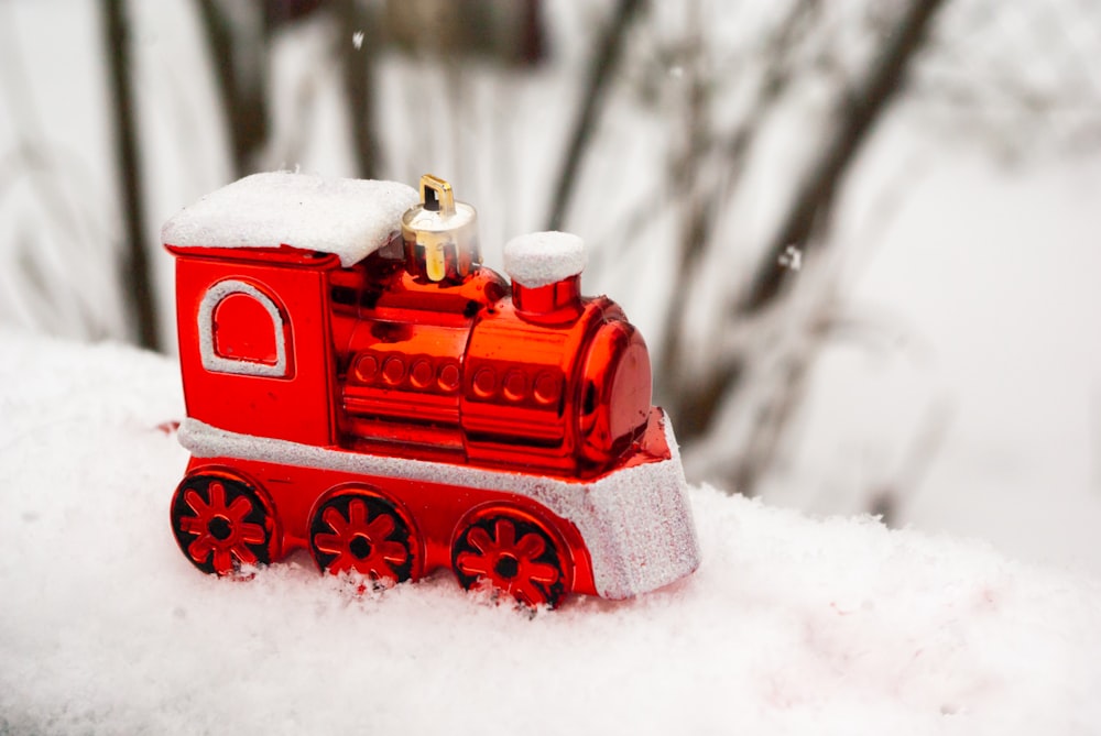 red and white house miniature on snow covered ground