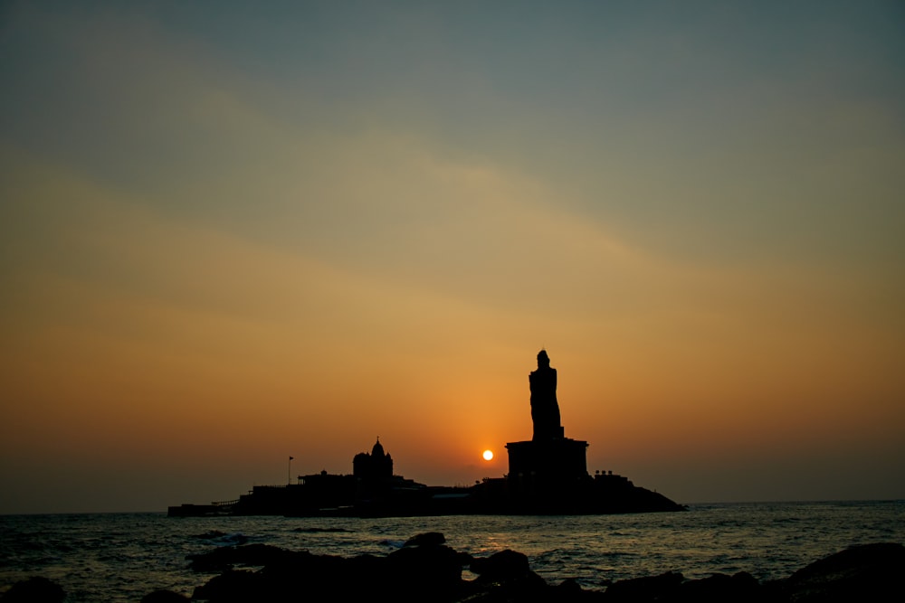 silhouette of lighthouse during sunset