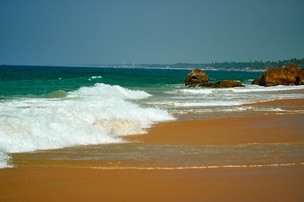 brown rock formation on sea shore during daytime