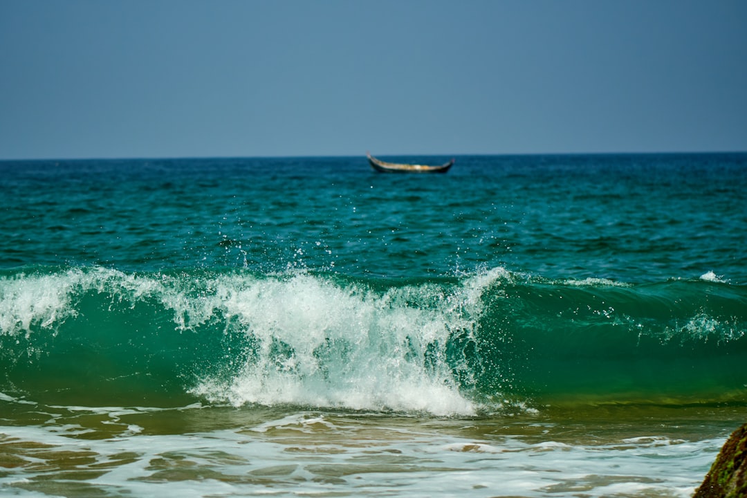 white boat on sea waves during daytime