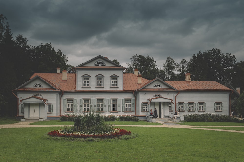 white and brown concrete house under gray sky