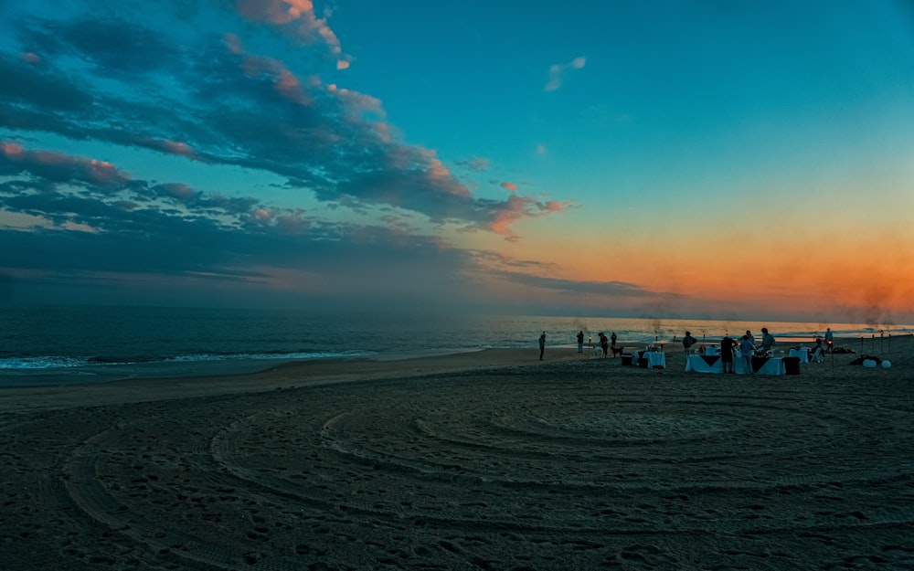 people on beach during sunset