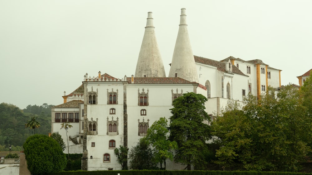 white concrete building near green trees during daytime