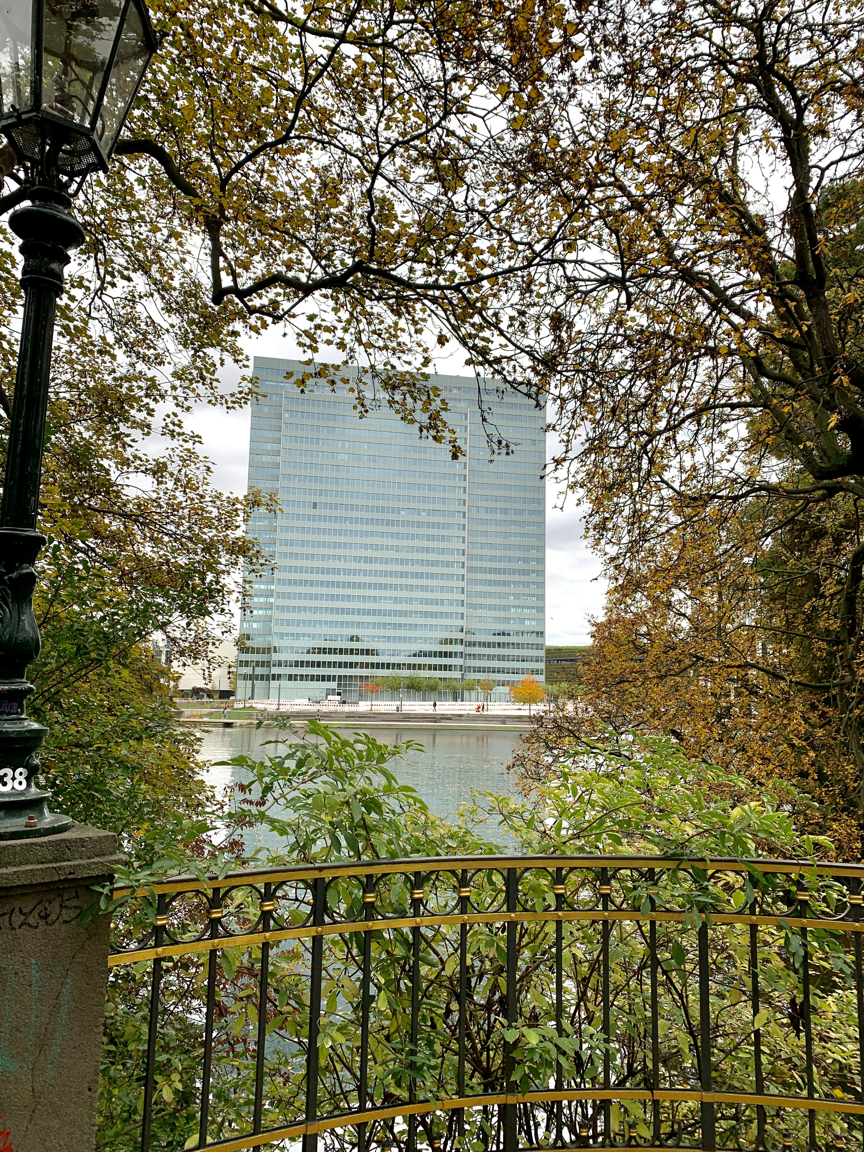 white and black concrete building near trees during daytime