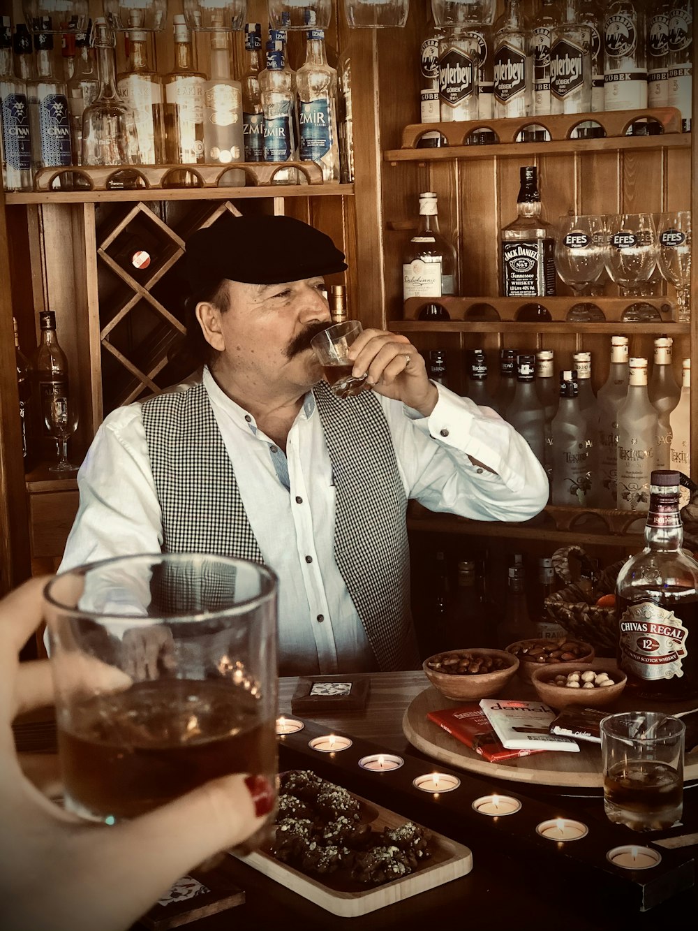 man in white dress shirt drinking beer