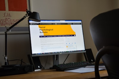 a desktop computer sitting on top of a wooden desk