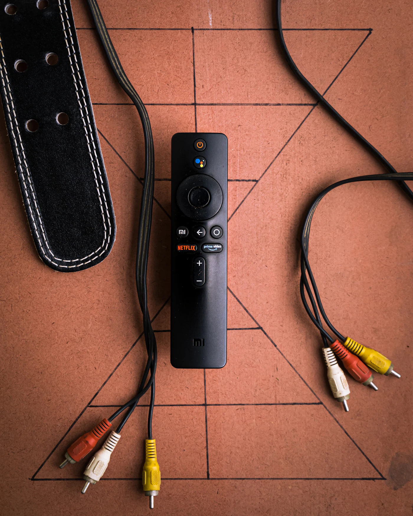 A black remote control on a table