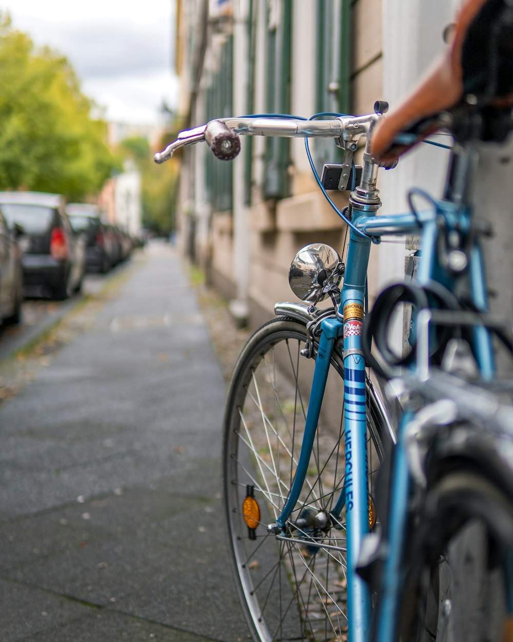 blue and silver bicycle on road during daytime