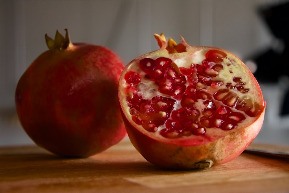 red pomegranate on brown wooden table