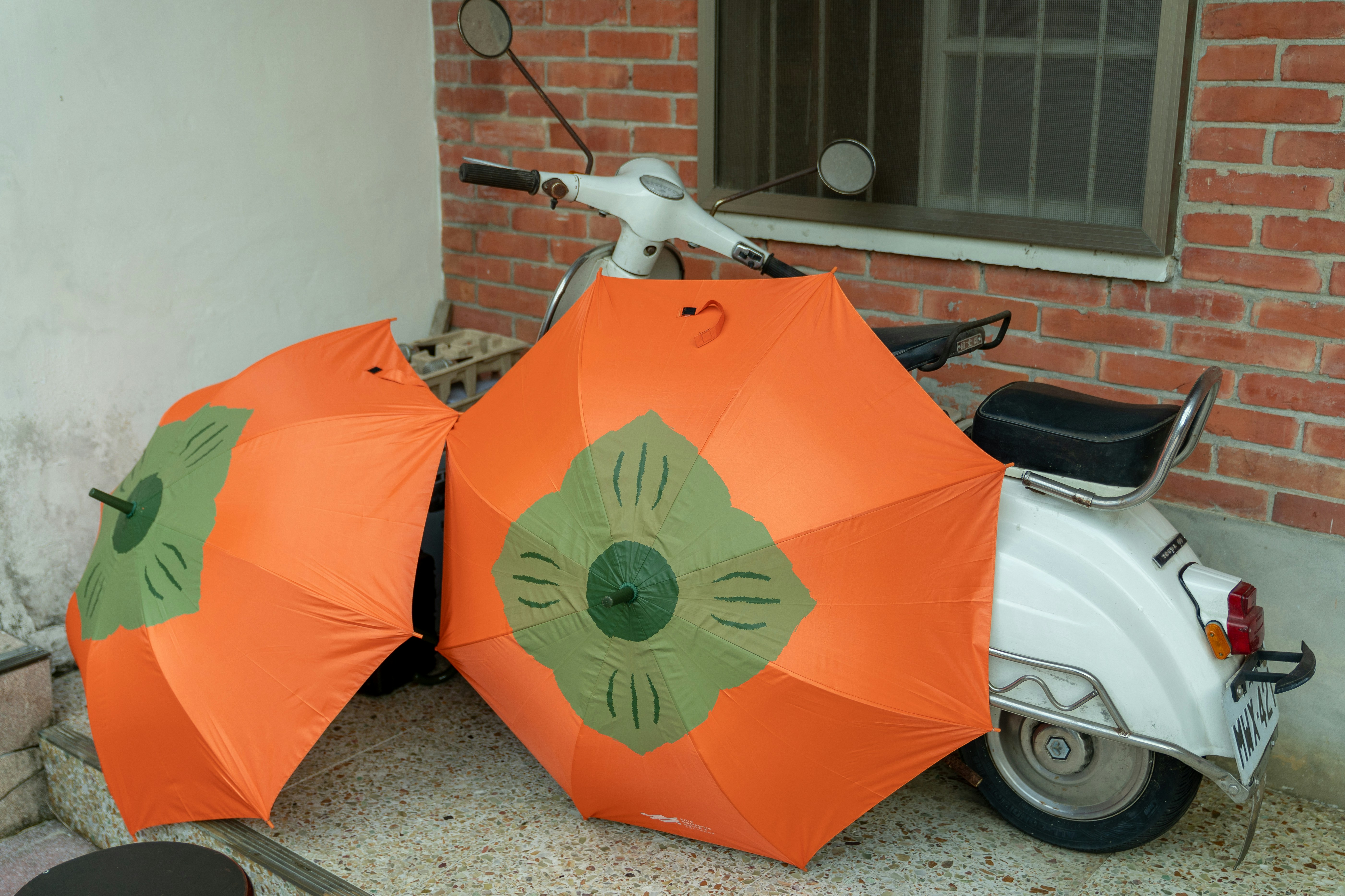 red umbrella on white car