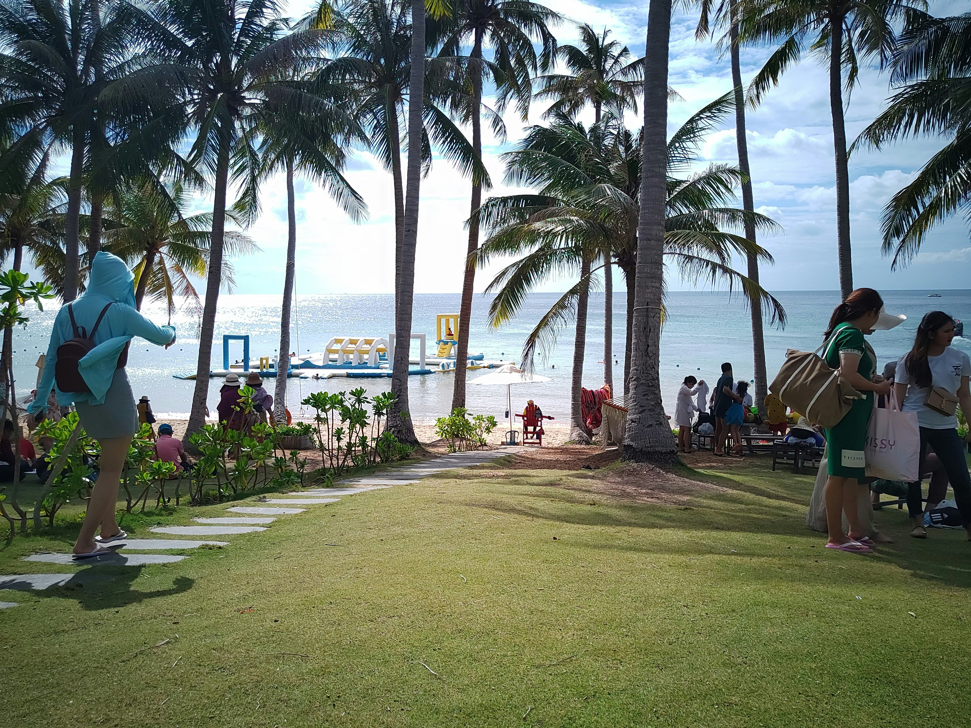 people sitting on beach chairs near beach during daytime