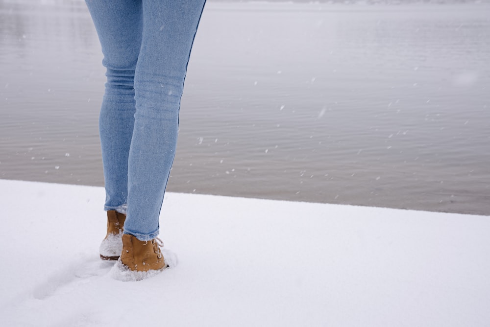 woman in brown skinny jeans and white sneakers