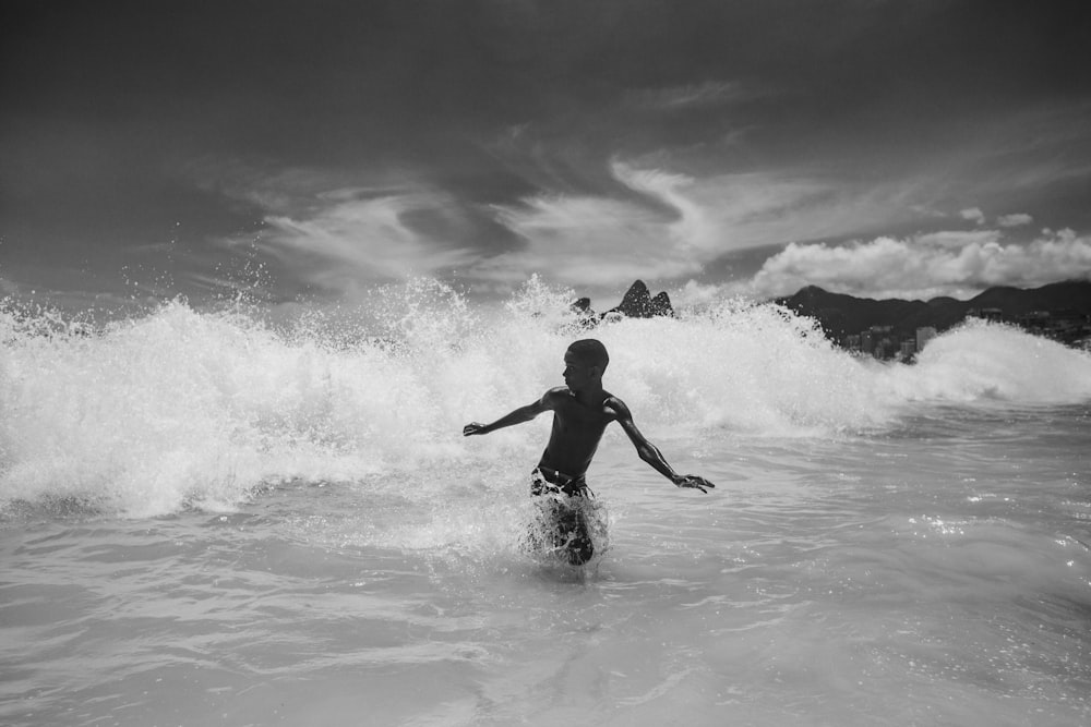 grayscale photo of woman in black bikini on water