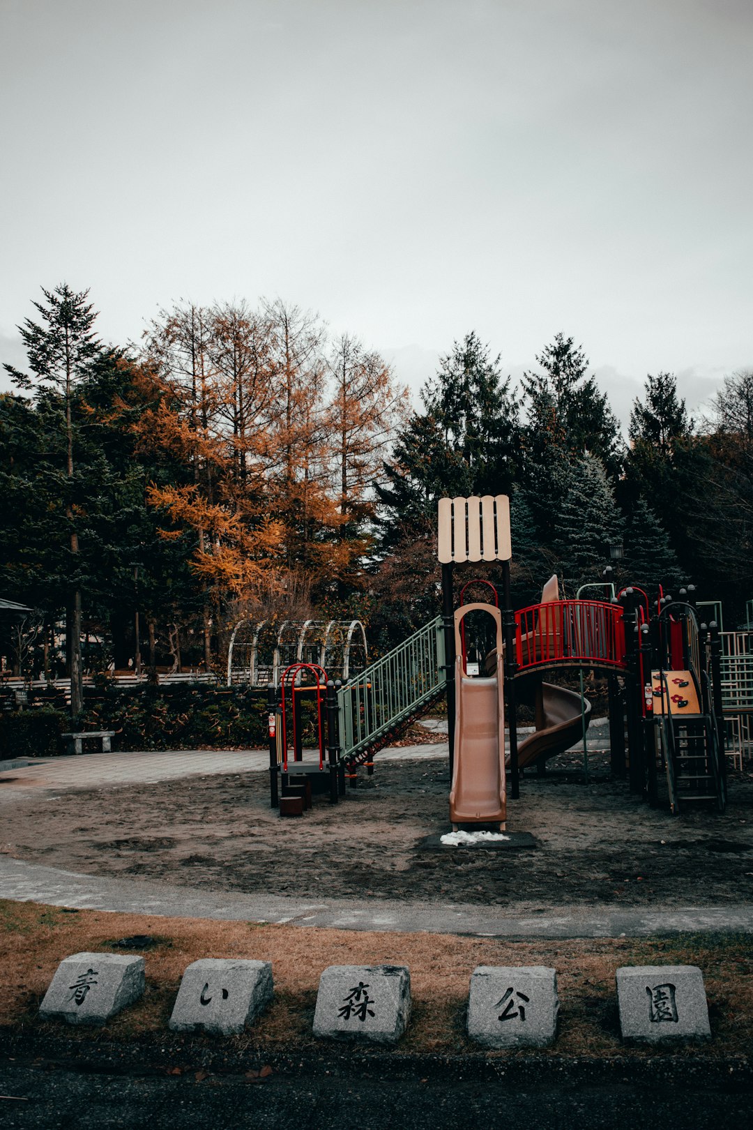 red wooden bridge near trees during daytime