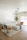A modern living room featuring a stylish ottoman box with a cozy sofa and natural light.