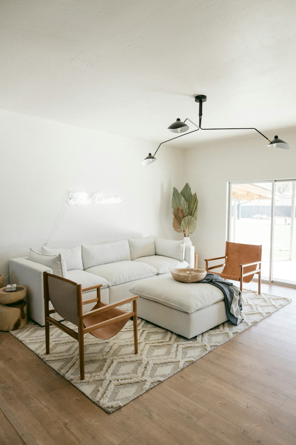 white sofa near brown wooden chair