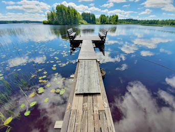 brown wooden dock over blue lake during daytime