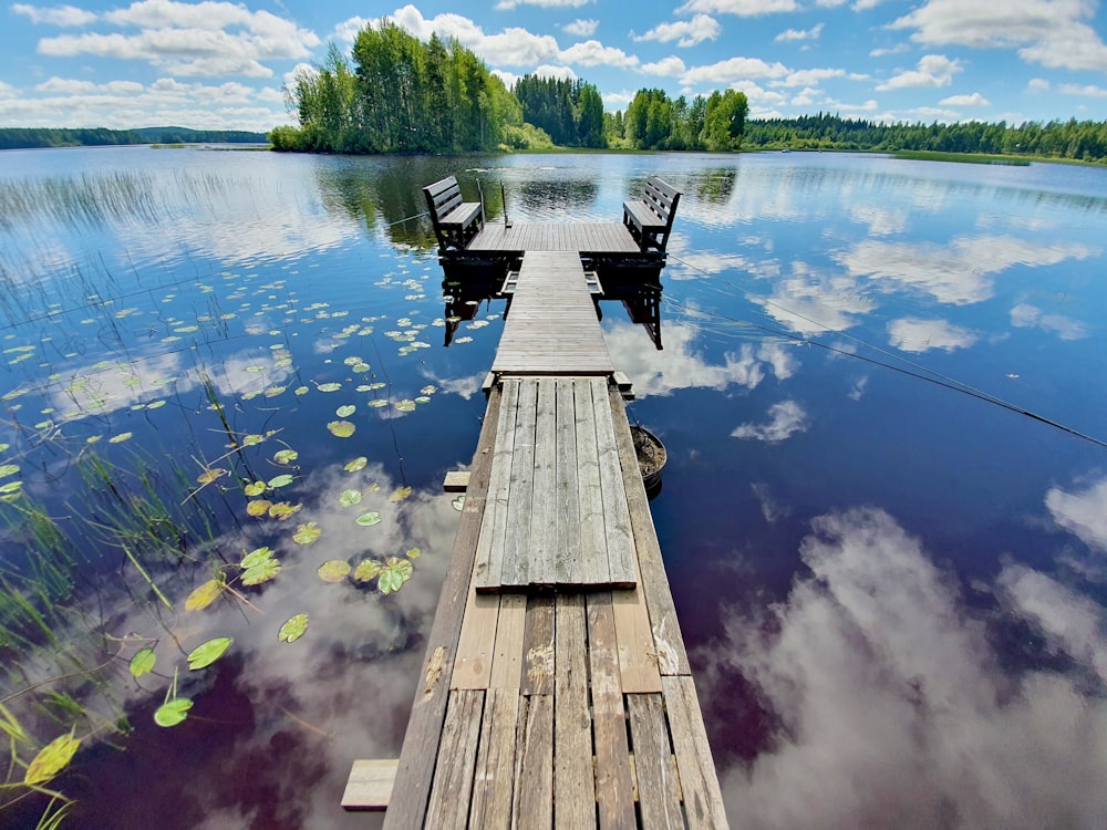 brown wooden dock over blue lake during daytime