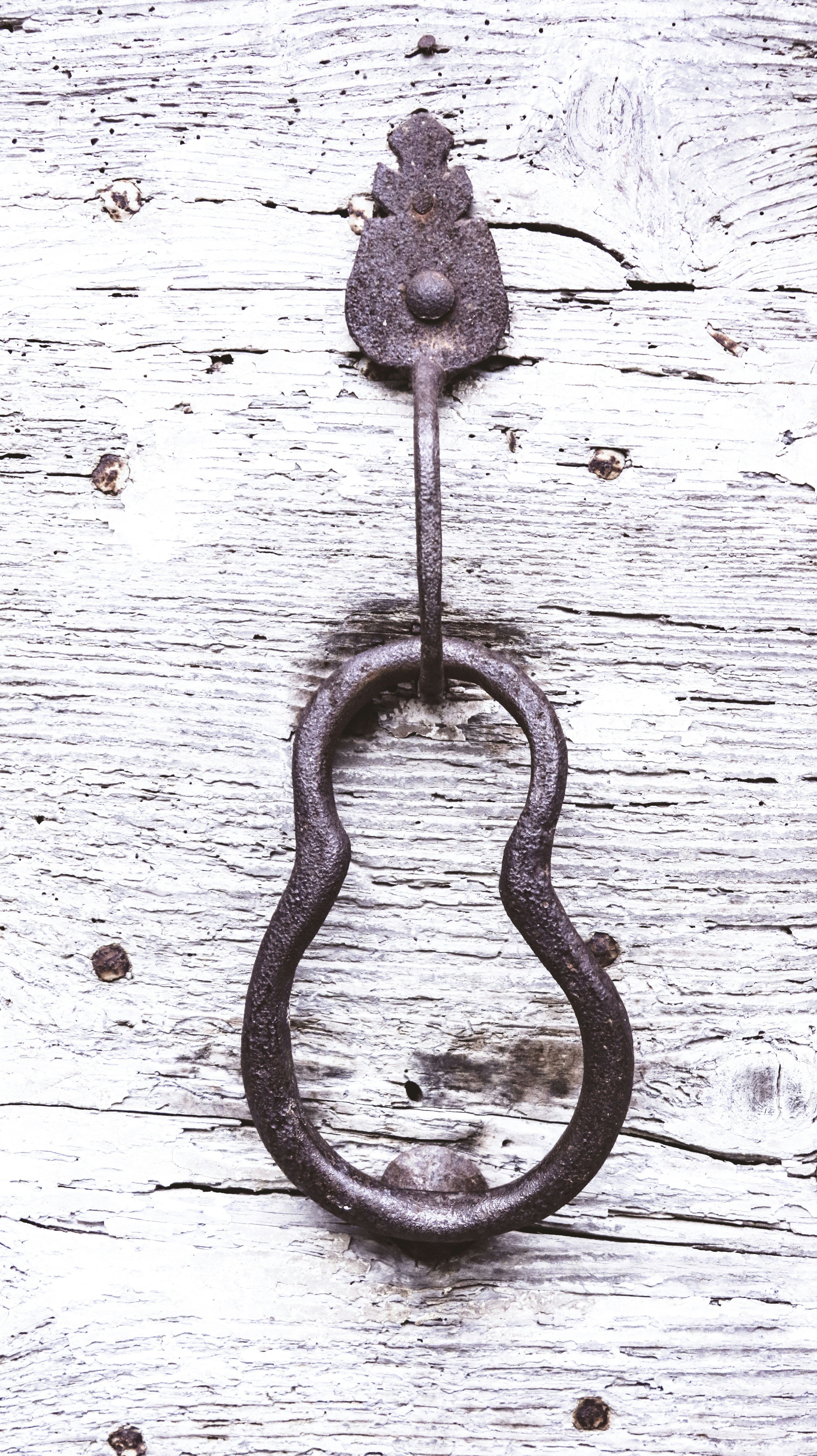 brown steel door handle on white wooden door