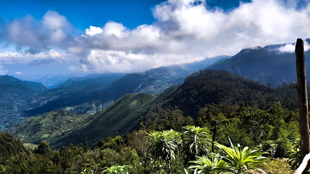 green mountain under white clouds during daytime