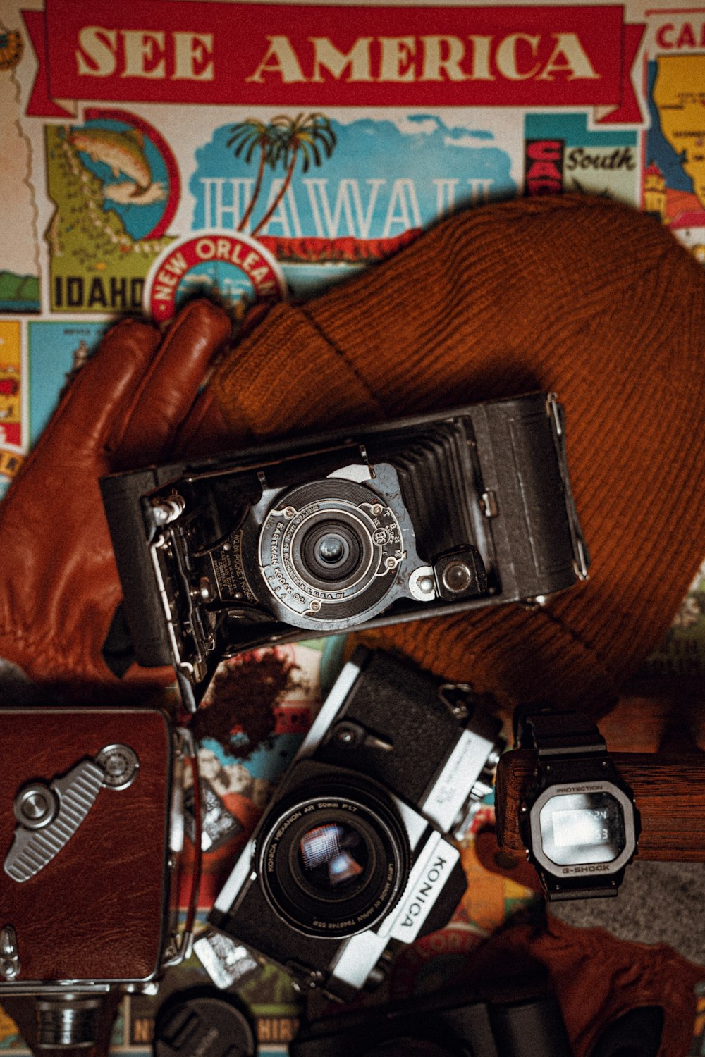 black and silver camera on brown leather case