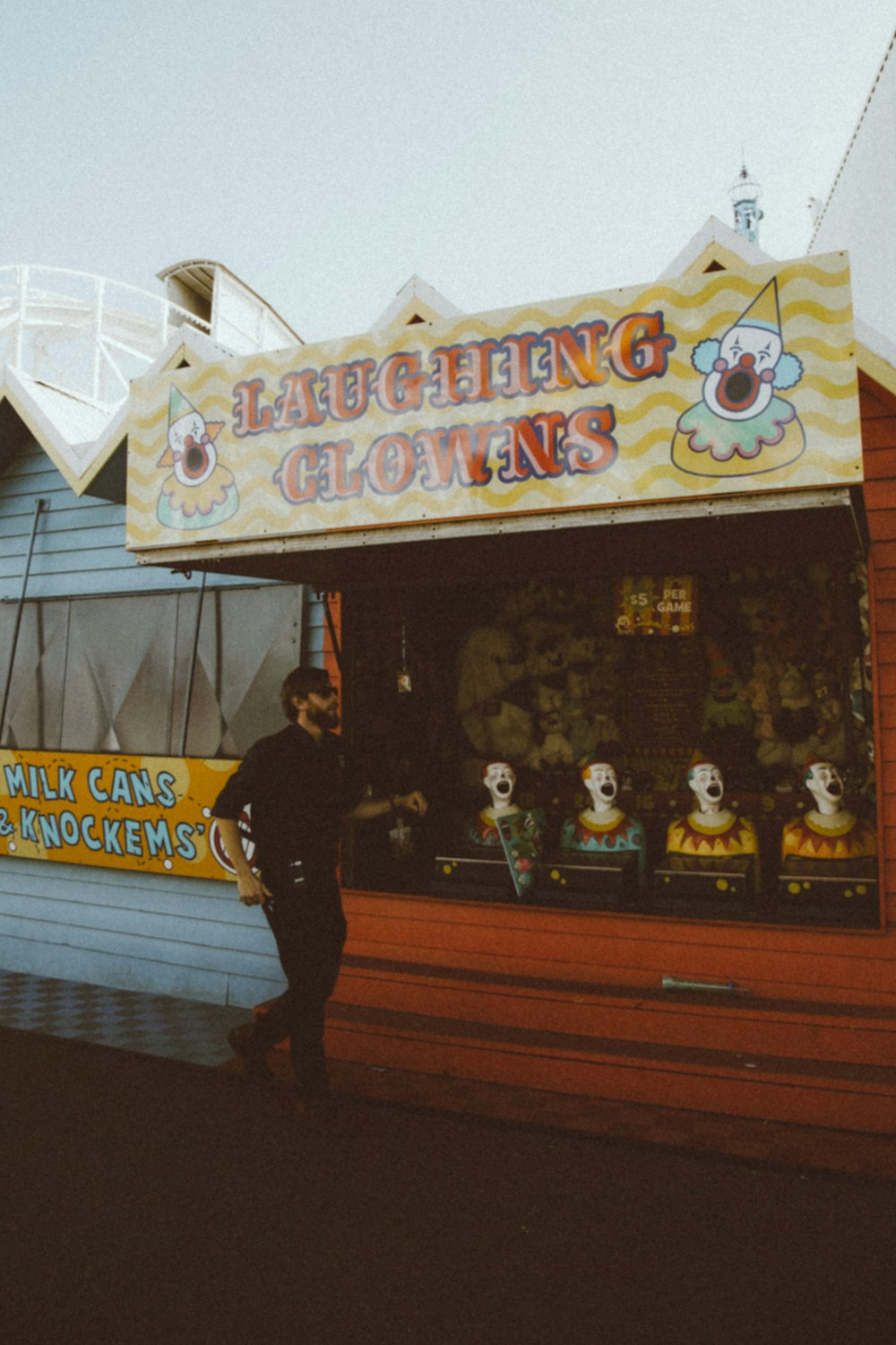 man in black jacket standing near the store