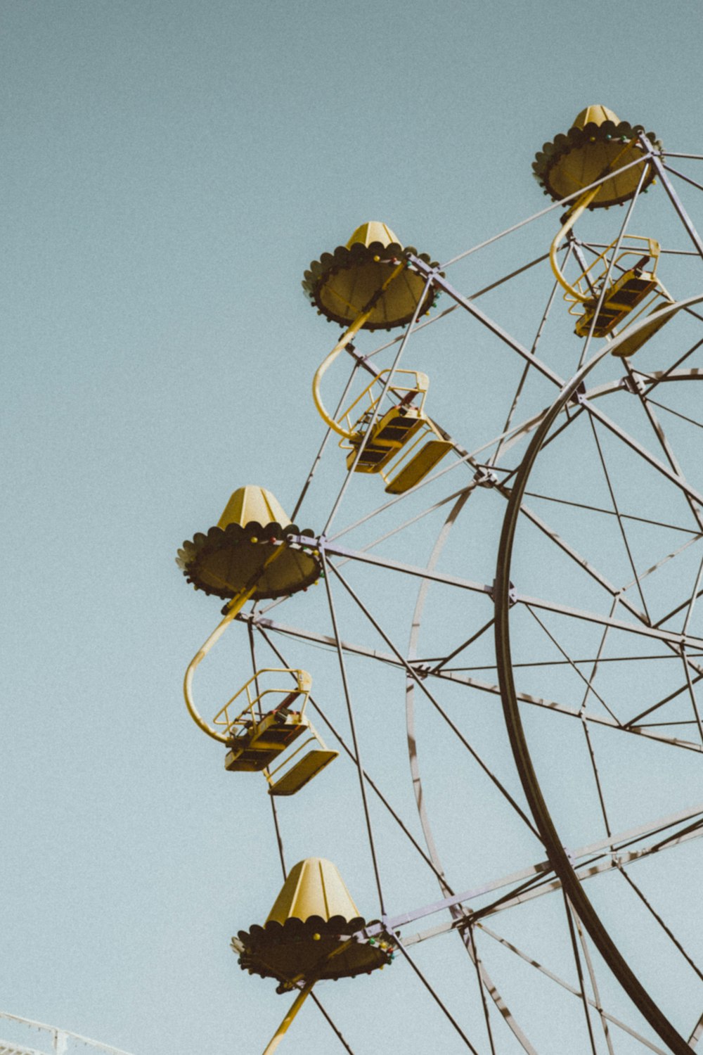 white and brown ferris wheel under blue sky during daytime