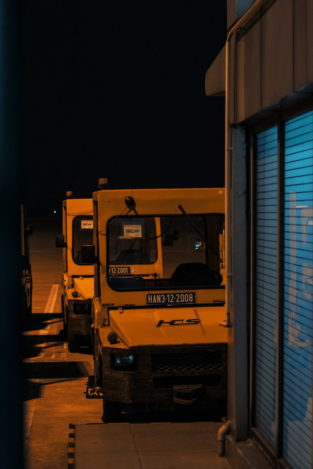 a row of yellow trucks parked next to each other