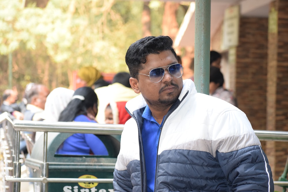 man in white dress shirt and black vest wearing black sunglasses