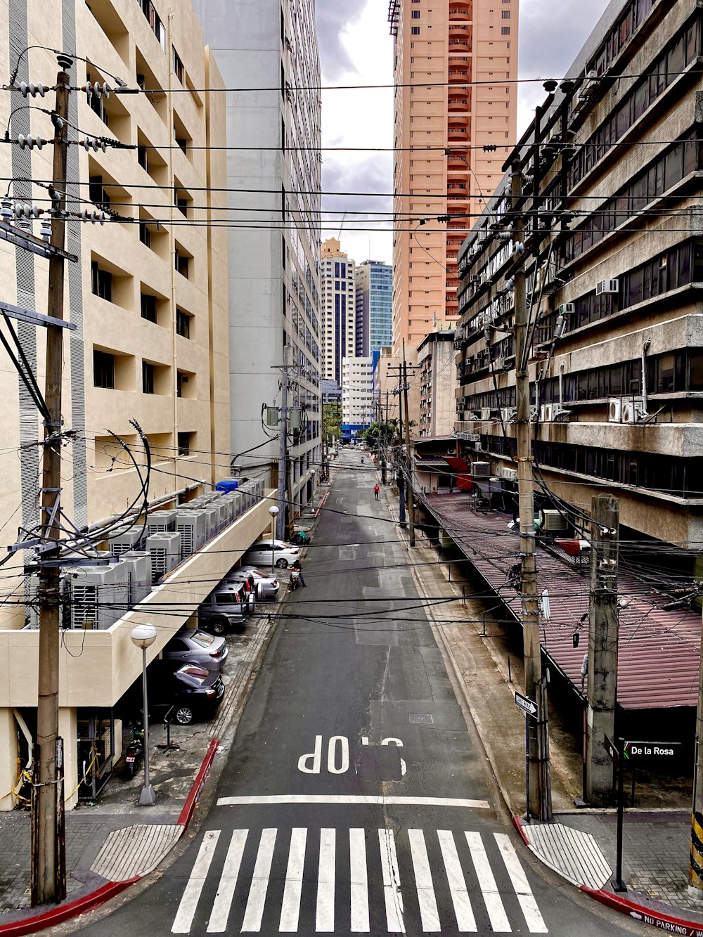 cars on road between buildings during daytime