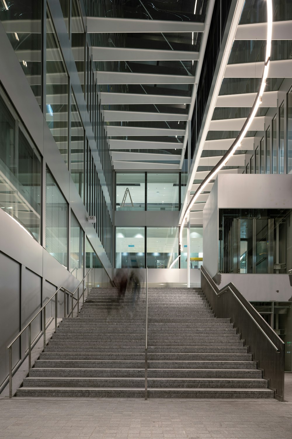 woman in black shirt walking on gray concrete stairs