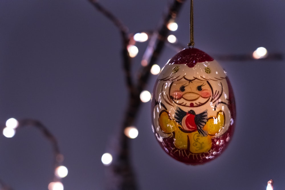 red and gold bauble on tree branch