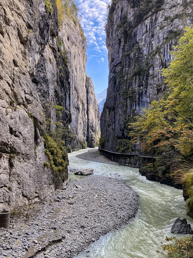 river between rocky mountains under blue sky during daytime