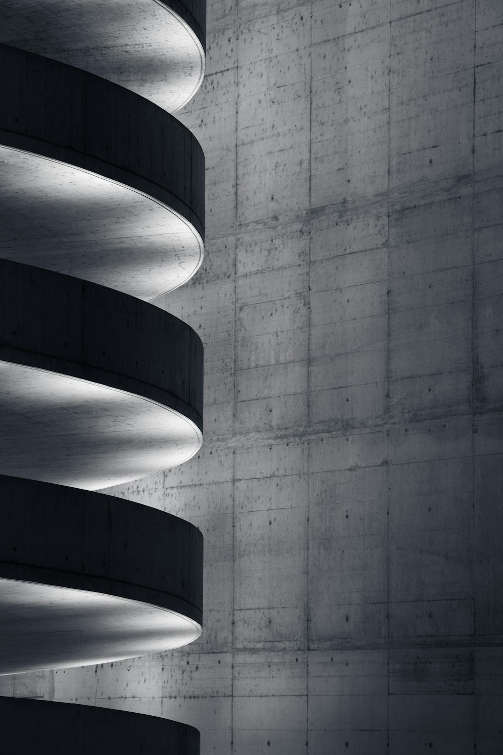 white spiral stairs in grayscale photography