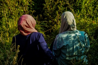 person in blue jacket and pink hijab