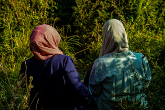person in blue jacket and pink hijab