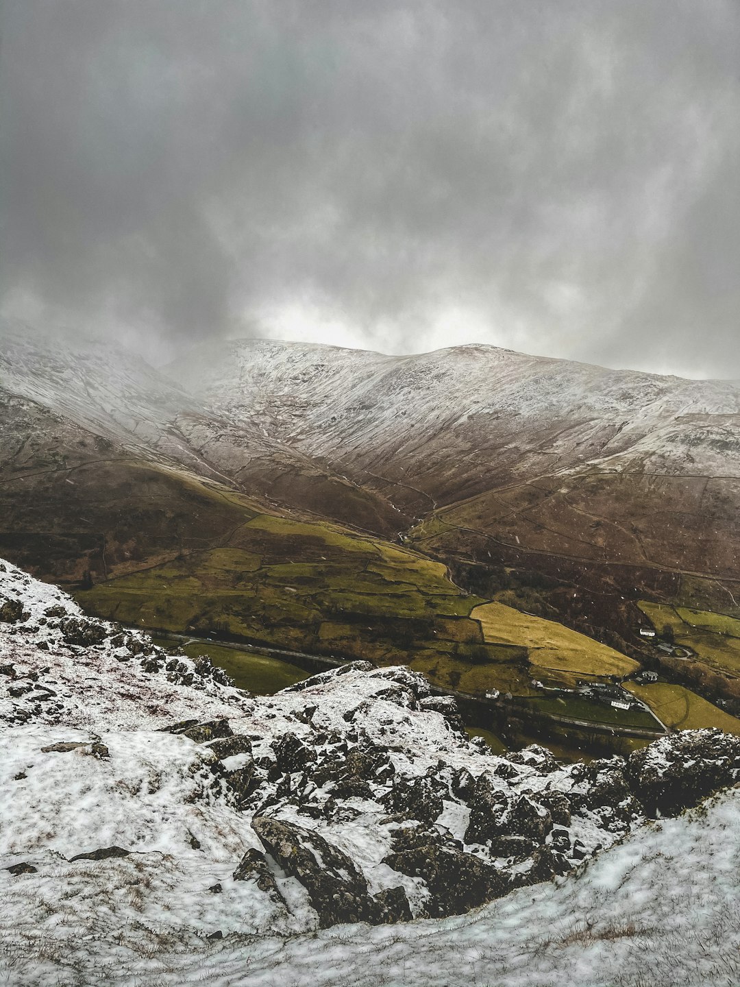 brown and gray mountains under white clouds during daytime