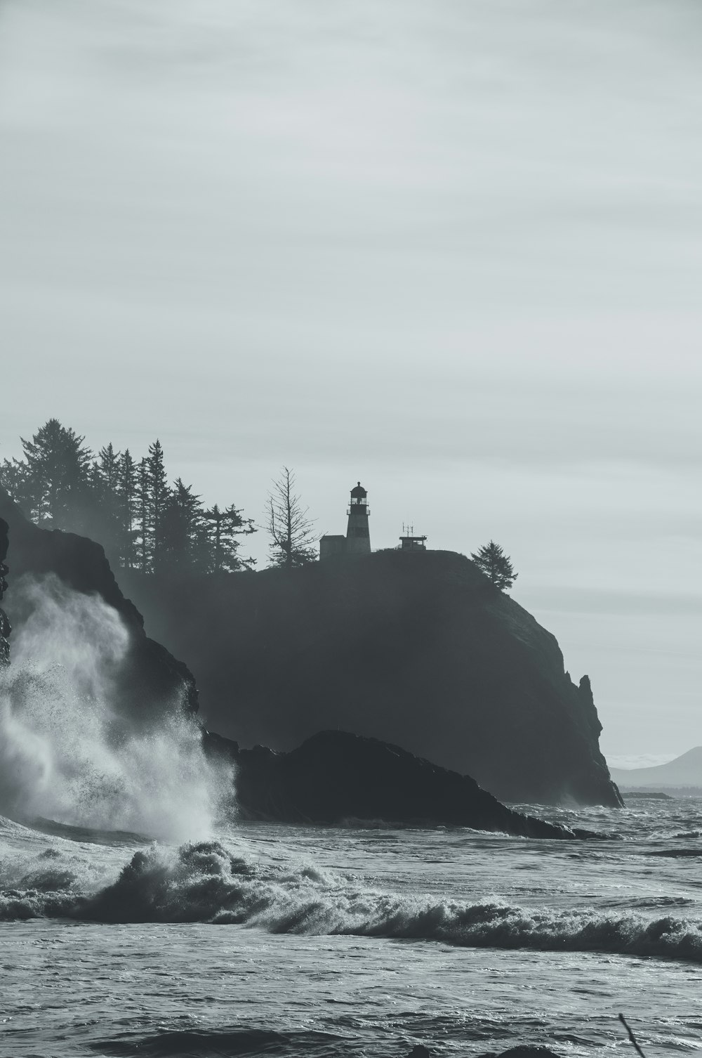 lighthouse on top of the hill by the sea