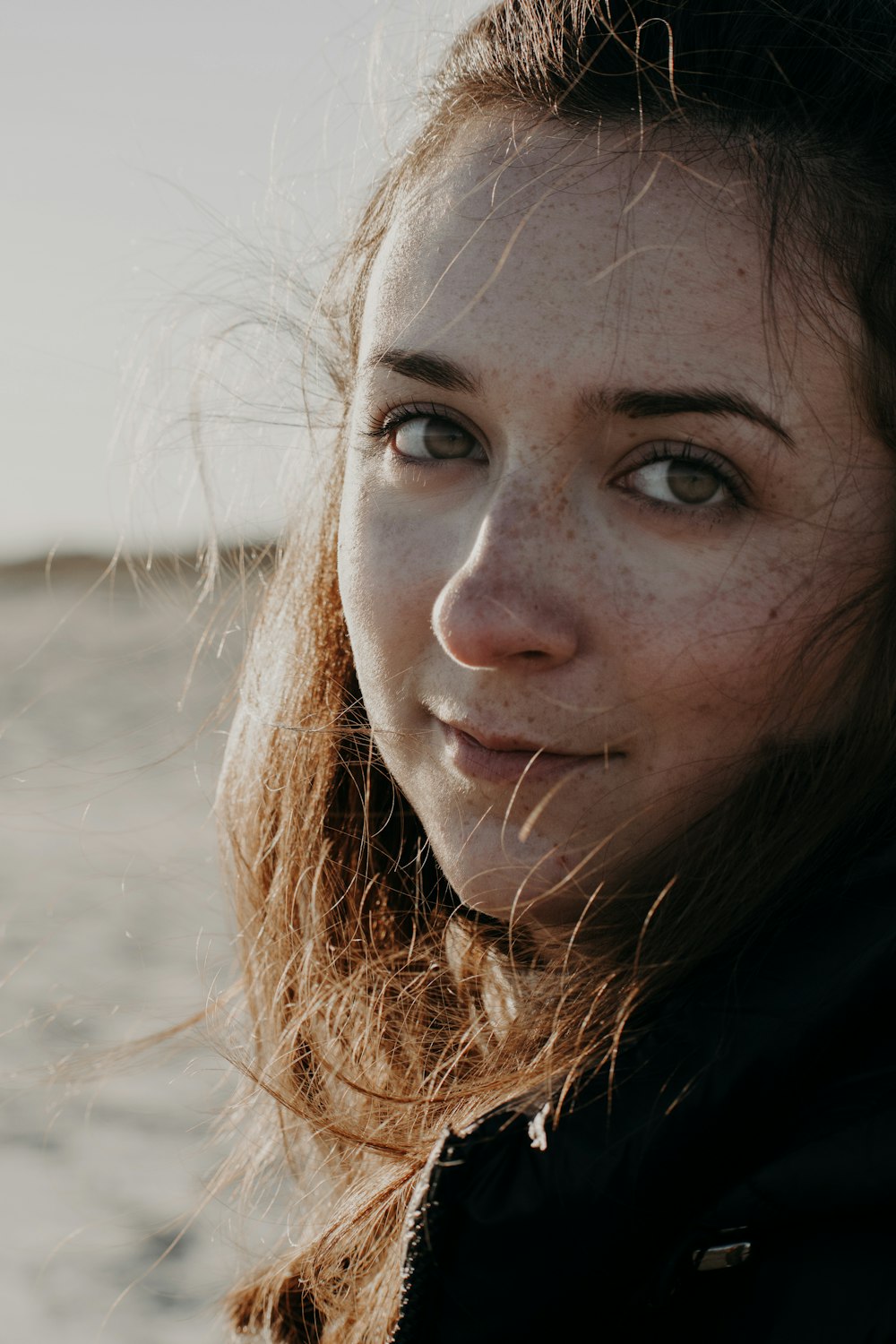 woman in black shirt with brown hair