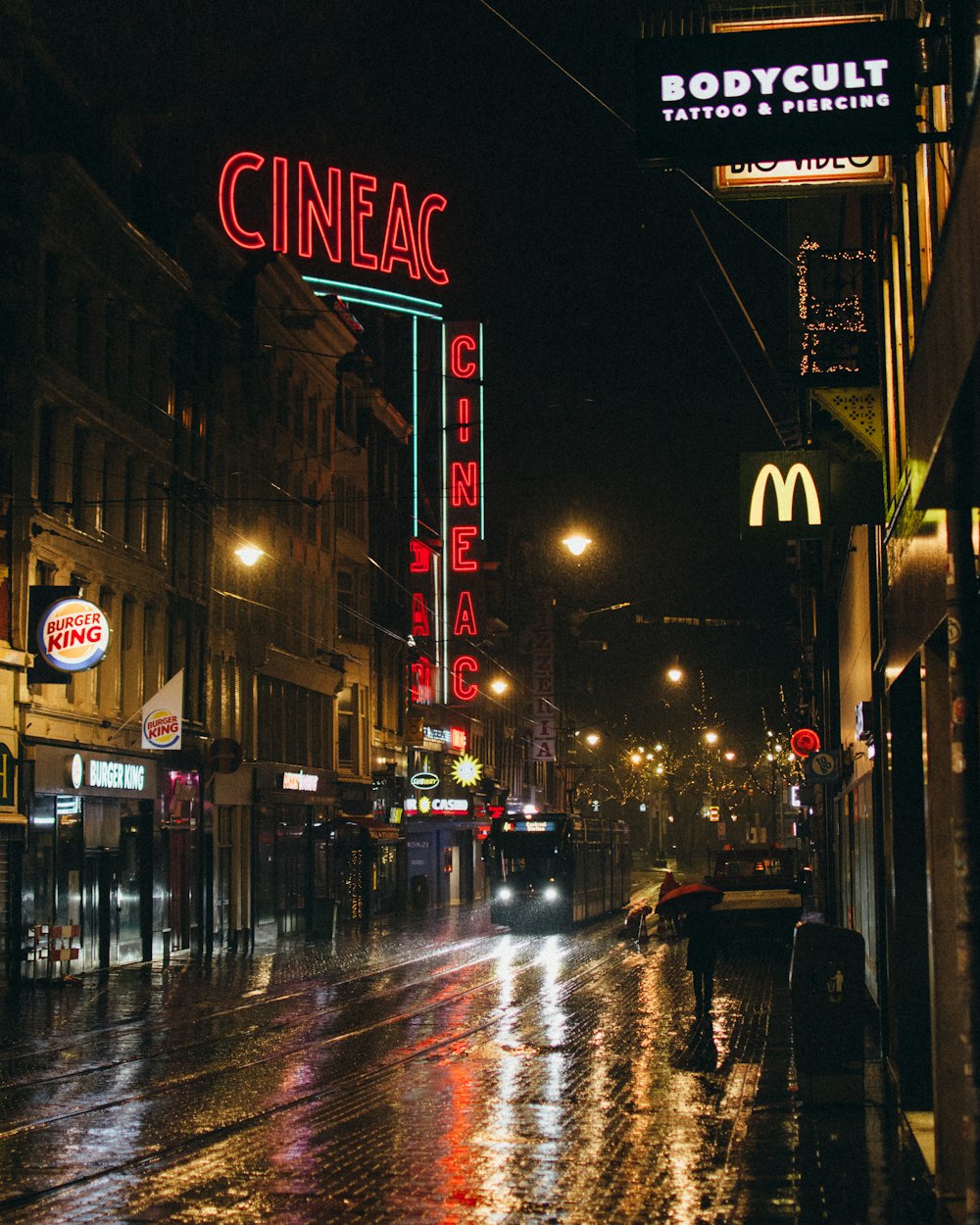 city street with red and white street sign during night time